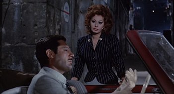 Movie still from “Marriage Italian Style” (1964), directed by Vittorio De Sica – A man and a woman are standing next to each other; Medium shot, Over the shoulder angle