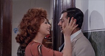 Movie still from “Marriage Italian Style” (1964), directed by Vittorio De Sica – An older woman and a younger man smiling at each other; Close Up shot, Over the shoulder angle