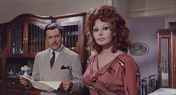 Movie still from “Marriage Italian Style” (1964), directed by Vittorio De Sica – A man and a woman standing next to each other in a room; Medium shot, Over the shoulder angle