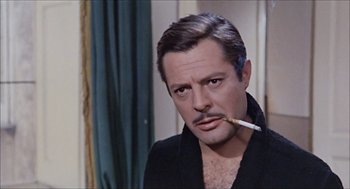 Movie still from “Marriage Italian Style” (1964), directed by Vittorio De Sica – A person with a cigarette in his mouth; Close Up shot, Over the shoulder angle