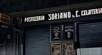 Movie still from “Marriage Italian Style” (1964), directed by Vittorio De Sica – A store front of a coffee shop with a sign on the side; Wide shot, Low angle