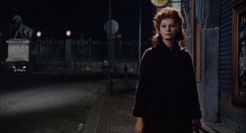 Movie still from “Marriage Italian Style” (1964), directed by Vittorio De Sica – A woman standing on the side of a road at night; Medium shot, Low angle