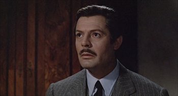 Movie still from “Marriage Italian Style” (1964), directed by Vittorio De Sica – A person wearing a suit and tie; Close Up shot, Over the shoulder angle