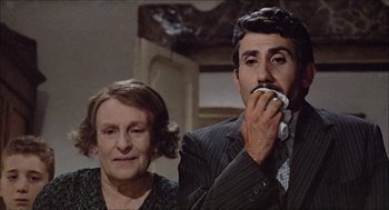 Movie still from “Marriage Italian Style” (1964), directed by Vittorio De Sica – An older woman and a younger man eating cake; Medium shot, Low angle