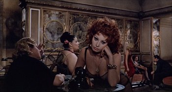 Movie still from “Marriage Italian Style” (1964), directed by Vittorio De Sica – A group of women sitting at a table in front of a mirror; Medium shot, Over the shoulder angle