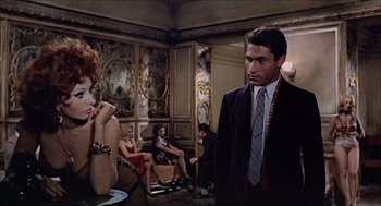 Movie still from “Marriage Italian Style” (1964), directed by Vittorio De Sica – A group of people sitting in a living room; Medium shot, Over the shoulder angle