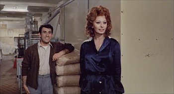 Movie still from “Marriage Italian Style” (1964), directed by Vittorio De Sica – A man standing next to a woman wearing a blue dress; Medium shot, Over the shoulder angle