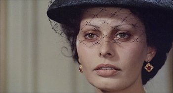 Movie still from “Marriage Italian Style” (1964), directed by Vittorio De Sica – A person wearing a hat; Close Up shot, Over the shoulder angle