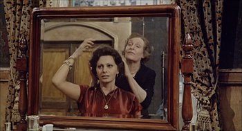Movie still from “Marriage Italian Style” (1964), directed by Vittorio De Sica – An older woman is getting her hair done in the mirror; Medium shot, Over the shoulder angle