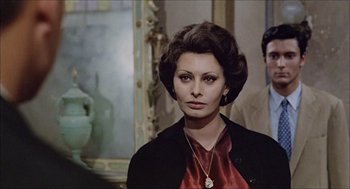 Movie still from “Marriage Italian Style” (1964), directed by Vittorio De Sica – A woman in a black jacket and a red dress; Close Up shot, Over the shoulder angle