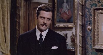 Movie still from “Marriage Italian Style” (1964), directed by Vittorio De Sica – A person wearing a suit and tie; Close Up shot, Over the shoulder angle