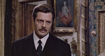 Movie still from “Marriage Italian Style” (1964), directed by Vittorio De Sica – A person wearing a suit and tie; Close Up shot, Over the shoulder angle
