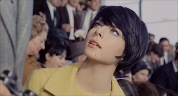 Movie still from “Marriage Italian Style” (1964), directed by Vittorio De Sica – A woman with short black hair looking up at a crowd; Close Up shot, Low angle