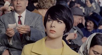 Movie still from “Marriage Italian Style” (1964), directed by Vittorio De Sica – A woman with short black hair wearing a yellow jacket; Close Up shot, High angle