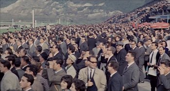Movie still from “Marriage Italian Style” (1964), directed by Vittorio De Sica – A large crowd of people in suits and ties; Extreme Wide shot, High angle