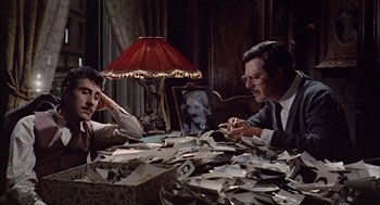 Movie still from “Marriage Italian Style” (1964), directed by Vittorio De Sica – A man and a woman sitting at a table with papers; Medium shot, High angle