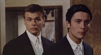Movie still from “Marriage Italian Style” (1964), directed by Vittorio De Sica – Two young men in suits standing next to each other; Close Up shot, Low angle