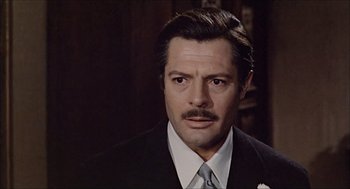 Movie still from “Marriage Italian Style” (1964), directed by Vittorio De Sica – A person wearing a suit and tie; Close Up shot, Over the shoulder angle