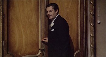 Movie still from “Marriage Italian Style” (1964), directed by Vittorio De Sica – A man in a suit standing in front of a wooden door; Medium shot, Low angle