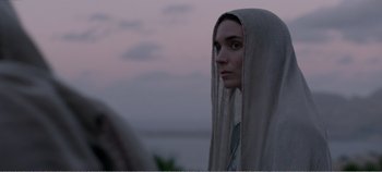 Movie still from “Mary Magdalene” (2018), directed by Garth Davis – A woman with a long white veil looking at the camera; Close Up shot, Over the shoulder angle