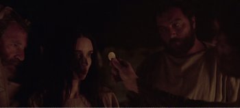 Movie still from “Mary Magdalene” (2018), directed by Garth Davis – A man and a woman are holding a piece of food; Close Up shot, Over the shoulder angle