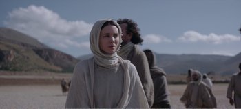 Movie still from “Mary Magdalene” (2018), directed by Garth Davis – A woman in a long white scarf standing next to a man; Medium shot, Over the shoulder angle