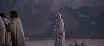 Movie still from “Mary Magdalene” (2018), directed by Garth Davis – A woman wearing a robe and a head covering; Medium shot, Over the shoulder angle