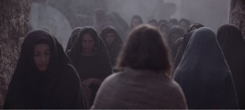 Movie still from “Mary Magdalene” (2018), directed by Garth Davis – A group of people gathered in a foggy area; Wide shot, Over the shoulder angle