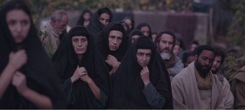 Movie still from “Mary Magdalene” (2018), directed by Garth Davis – A group of people wearing black robes and covering their faces; Wide shot, High angle