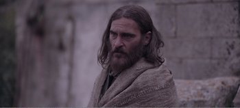 Movie still from “Mary Magdalene” (2018), directed by Garth Davis – A man with long hair and a beard wearing a blanket; Close Up shot, Low angle