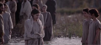 Movie still from “Mary Magdalene” (2018), directed by Garth Davis – A group of people standing in a body of water; Medium shot, Over the shoulder angle