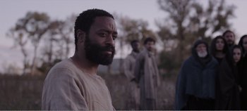 Movie still from “Mary Magdalene” (2018), directed by Garth Davis – A group of men standing next to each other in a field; Close Up shot, Over the shoulder angle