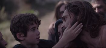 Movie still from “Mary Magdalene” (2018), directed by Garth Davis – A young man with his hands on his face and a young boy with his hands on his face; Close Up shot, Over the shoulder angle