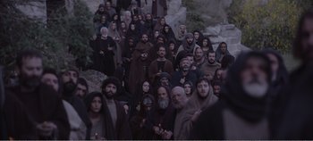 Movie still from “Mary Magdalene” (2018), directed by Garth Davis – A large group of men and women dressed in black; Extreme Wide shot, High angle