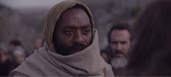 Movie still from “Mary Magdalene” (2018), directed by Garth Davis – A man with a beard is wearing a blanket; Close Up shot, Over the shoulder angle