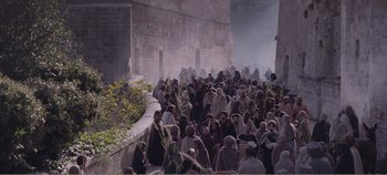 Movie still from “Mary Magdalene” (2018), directed by Garth Davis – A group of people standing next to each other near a wall; Extreme Wide shot, High angle