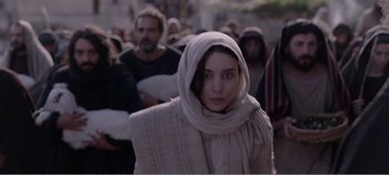Movie still from “Mary Magdalene” (2018), directed by Garth Davis – A group of people walking down a street; Medium shot, Low angle
