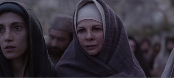 Movie still from “Mary Magdalene” (2018), directed by Garth Davis – A woman wrapped in a blanket with a man behind her; Close Up shot, Over the shoulder angle
