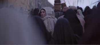 Movie still from “Mary Magdalene” (2018), directed by Garth Davis – A group of people walking down a street; Medium shot, Over the shoulder angle