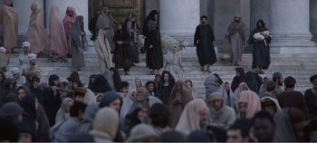 Movie still from “Mary Magdalene” (2018), directed by Garth Davis – A group of people dressed in biblical clothing and standing on some steps; Wide shot, High angle