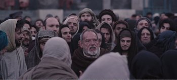 Movie still from “Mary Magdalene” (2018), directed by Garth Davis – A group of people gathered around a man wearing a beard; Medium shot, Over the shoulder angle