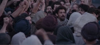 Movie still from “Mary Magdalene” (2018), directed by Garth Davis – A group of people standing in the middle of a crowd; Medium shot, High angle