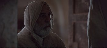 Movie still from “Mary Magdalene” (2018), directed by Garth Davis – An old man with a beard and a white turban; Close Up shot, Over the shoulder angle