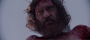 Movie still from “Mary Magdalene” (2018), directed by Garth Davis – A person wearing a crown of thorns; Close Up shot, Low angle