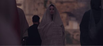 Movie still from “Mary Magdalene” (2018), directed by Garth Davis – A woman wrapped in a towel standing next to a man; Medium shot, Over the shoulder angle