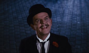 Movie still from “Mary Poppins” (1964), directed by Robert Stevenson – A person wearing a suit and a top hat; Close Up shot, Low angle