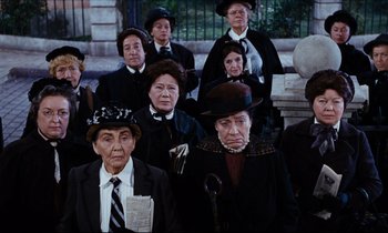 Movie still from “Mary Poppins” (1964), directed by Robert Stevenson – A group of people in old fashioned clothing; Medium shot, High angle