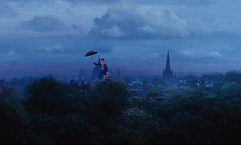 Movie still from “Mary Poppins” (1964), directed by Robert Stevenson – A man holding an umbrella over his head while standing on top of a hill; Extreme Wide shot, Low angle