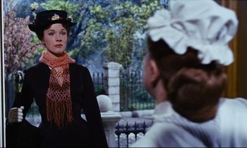 Movie still from “Mary Poppins” (1964), directed by Robert Stevenson – A woman wearing a hat and scarf in a scene from mary poppins; Medium shot, Low angle
