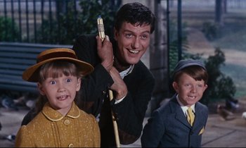 Movie still from “Mary Poppins” (1964), directed by Robert Stevenson – A group of young boys and an older man holding a pen; Medium shot, Low angle
